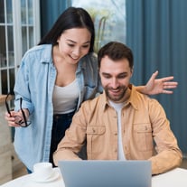 smiley-couple-shopping-online-laptop